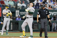 Oakland Athletics' Seth Brown scores on his solo home run against the Texas Rangers during the second inning of a baseball game Thursday, April 11, 2024, in Arlington, Texas. (AP Photo/Michael Ainsworth)