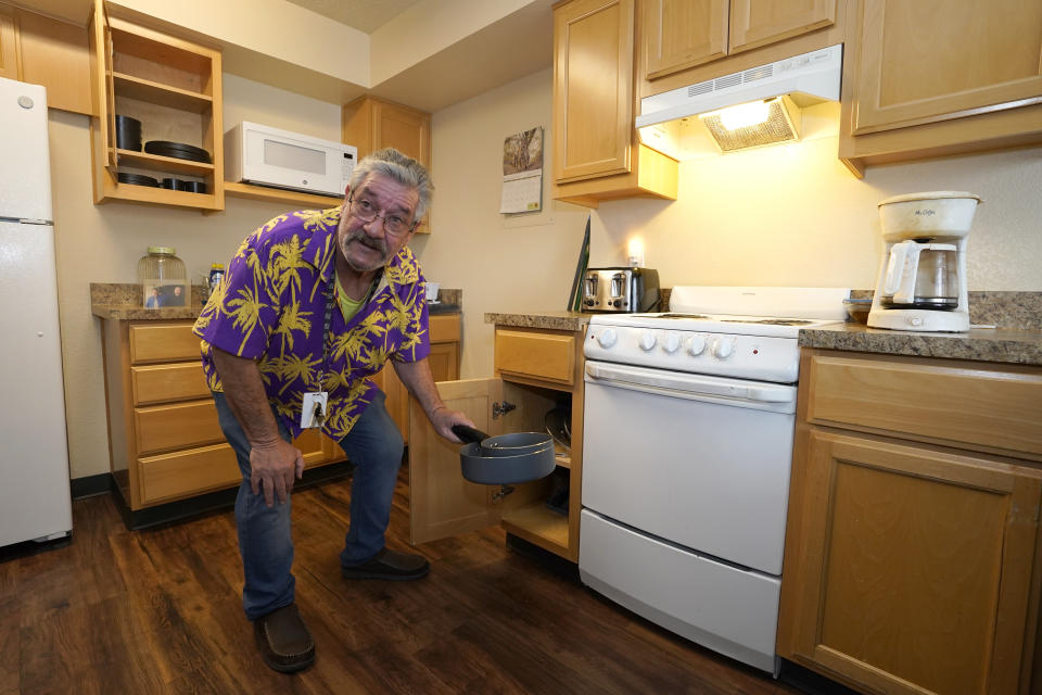Thomas Marshall shows off some of the cookware in the kitchen of his one bedroom apartment in Sacramento Calif., on February 24, 2023. Marshall, who had been homeless, got the apartment through a program championed by Gov. Gavin Newsom, to use some of the state's Medicaid money to pay for up to six months of housing for some people, including those who are homeless or at risk of becoming homeless. (AP Photo/Rich Pedroncelli)