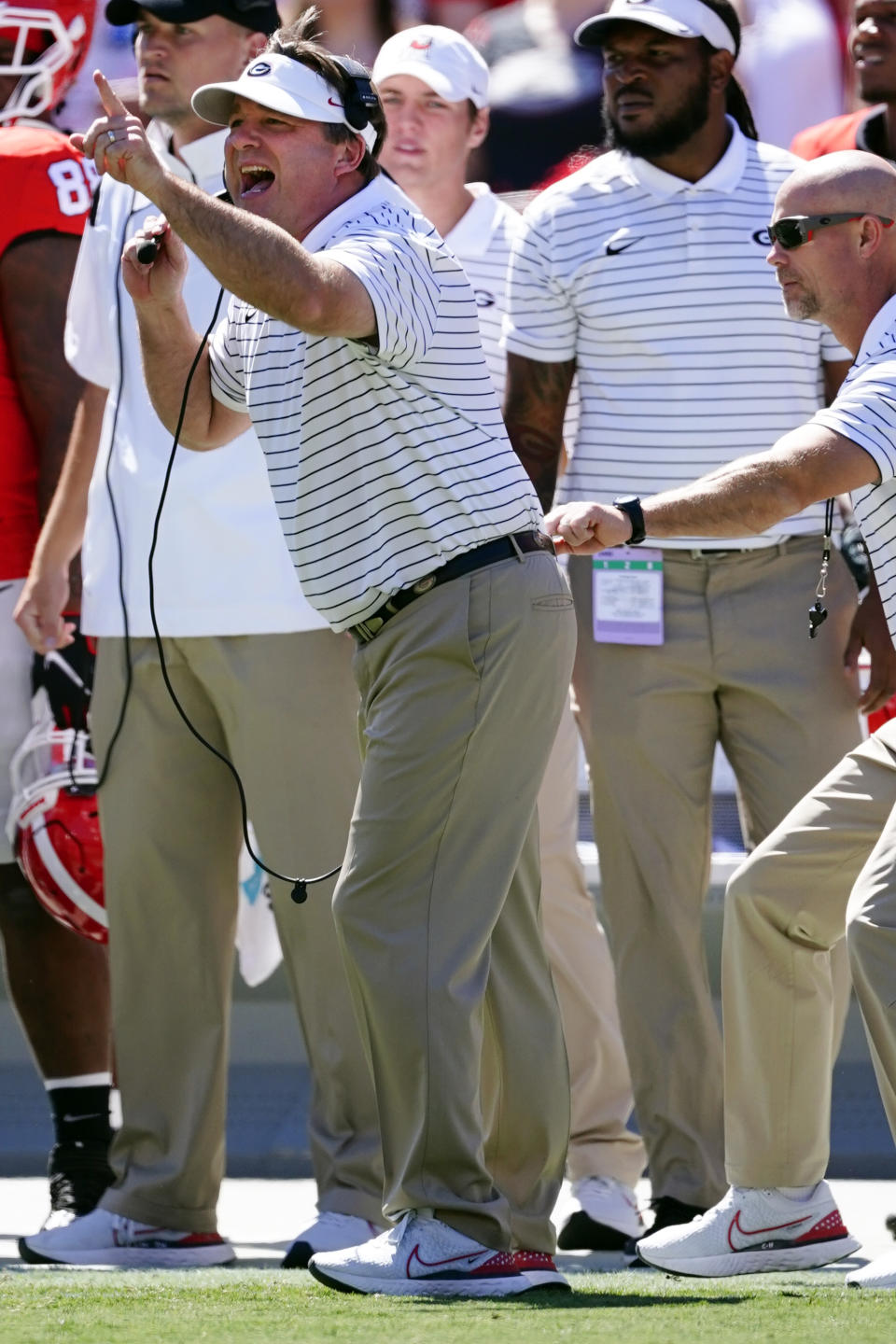 Georgia head coach Kirby Smart, left, is pulled off the field by an assistant coach as he yells to his players in the first half of an NCAA college football game against Kent State Saturday, Sept. 24, 2022, in Athens, Ga. (AP Photo/John Bazemore)