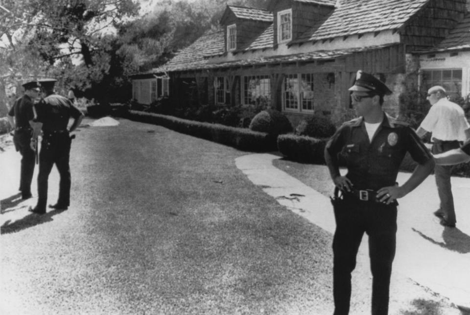Police stand guard outside the home of film director Roman Polanski, following the murder of his wife Sharon Tate, and four other people by Charles Manson and his ‘family’ in 1969 (Popperfoto via Getty Images)