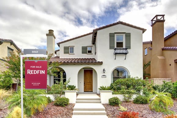 A house with a Redfin "for sale" sign outside of it