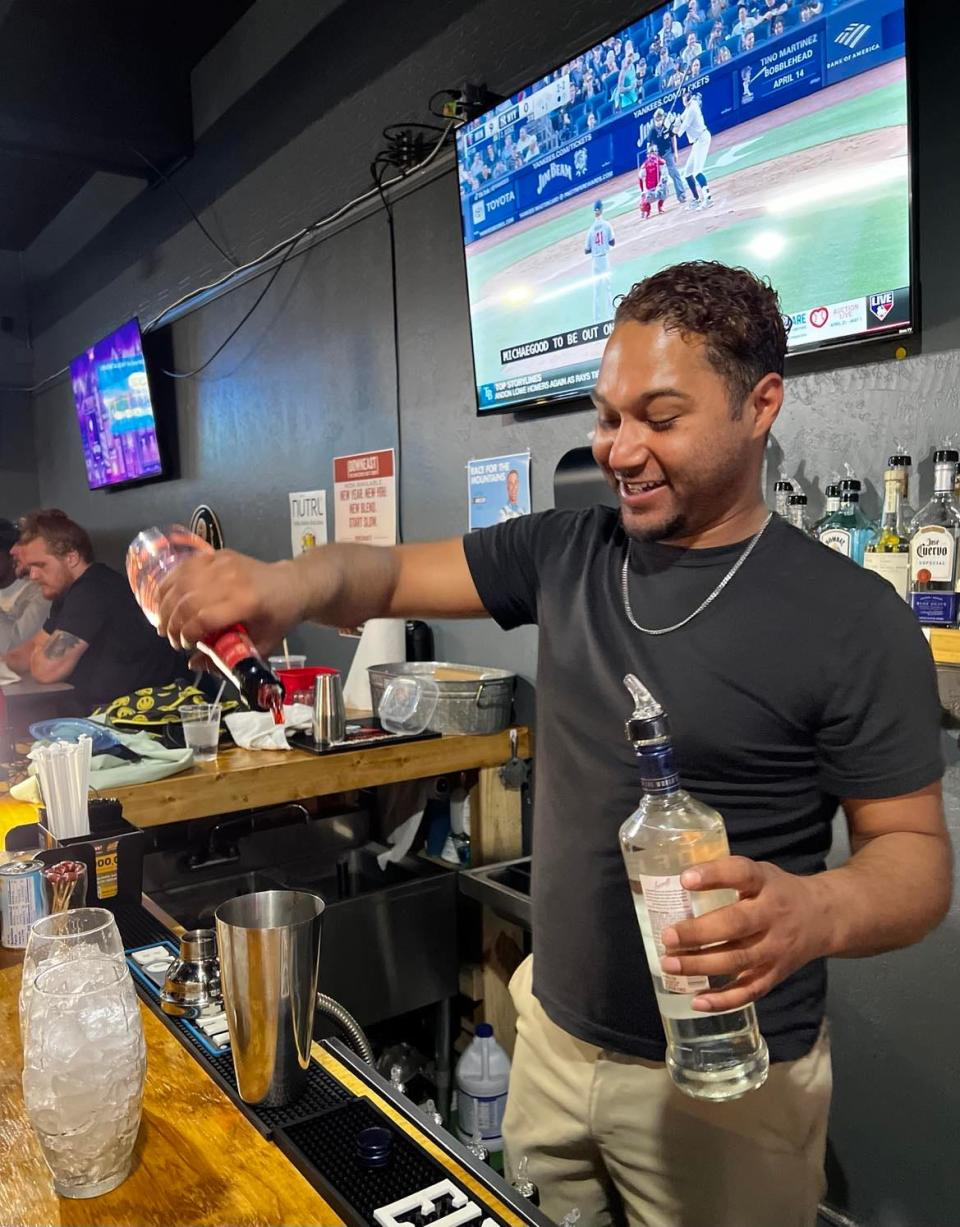 Jamal Gomez, head bartender and manager of Gridiron Pizza & Sports Bar, is a mixologist who has created a new cocktail and drink menu for the downtown Canton eatery and hangout spot.