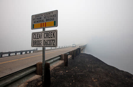 Smoke from the Carr Fire shrouds the Clear Creek Bridge near Igo, California, U.S. July 29, 2018. REUTERS/Bob Strong