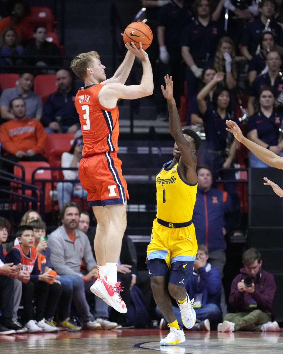 Illinois forward Marcus Domask (3) shoots as Marquette guard Kam Jones defends during the second half of an NCAA college basketball game Tuesday, Nov. 14, 2023, in Champaign, Ill. Marquette won 71-64. (AP Photo/Charles Rex Arbogast)