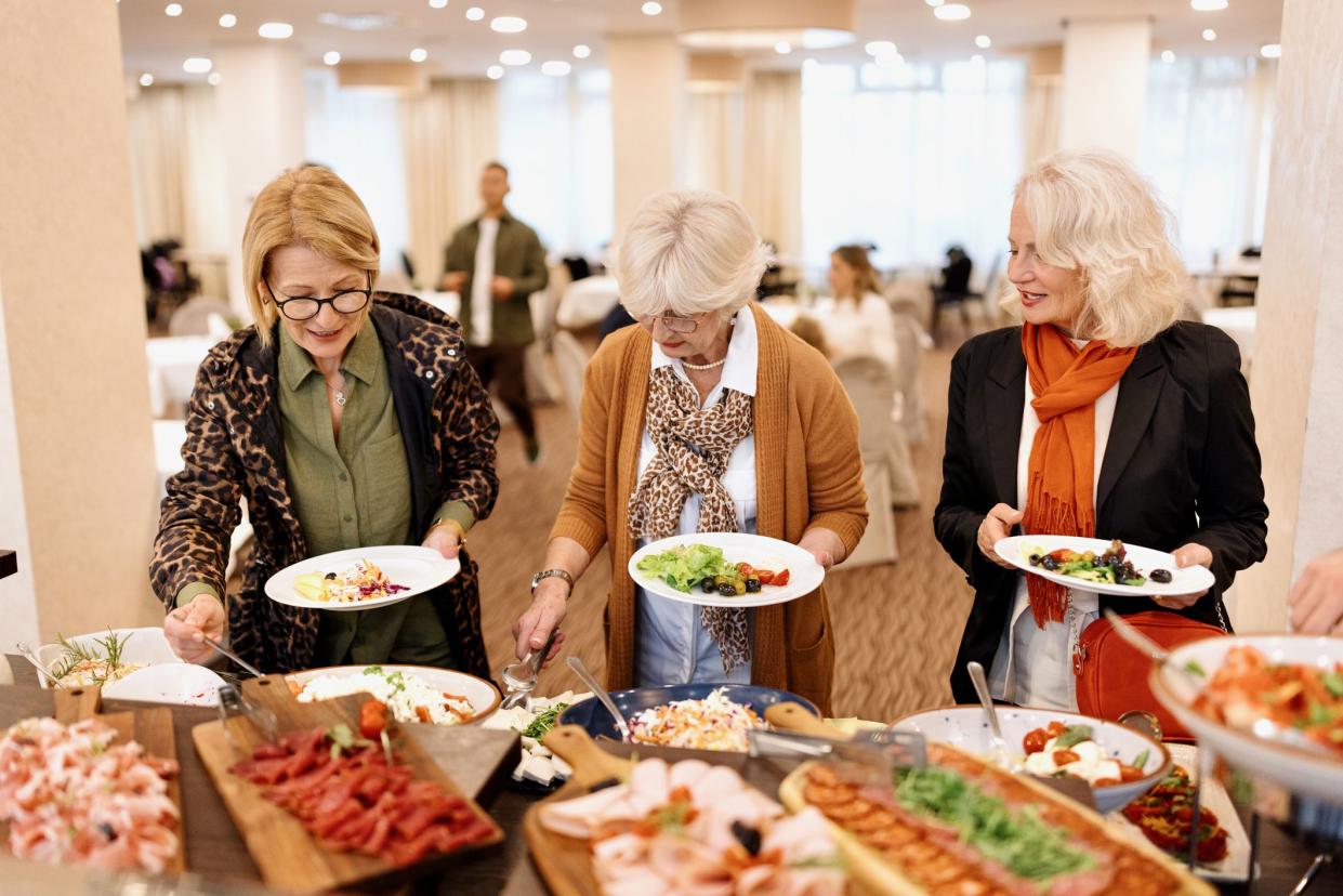 Food Buffet Catering Dining Eating Party Sharing Concept. Multi ethnic people group catering buffet food breakfast indoor in luxury hotel restaurant with meat colourful fruits and vegetables