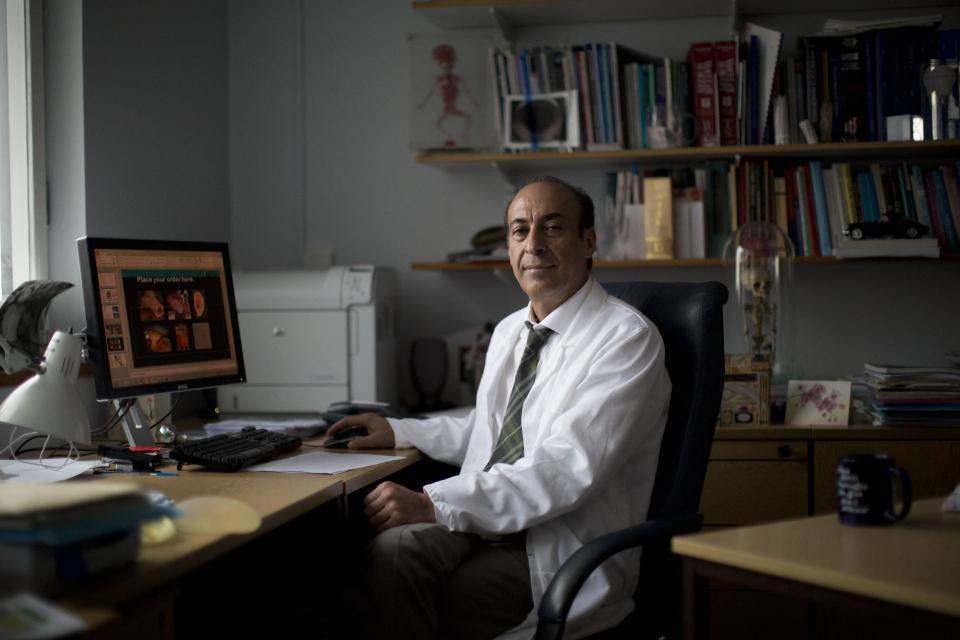 Professor Alexander Seifalian poses for a portrait in his office at his research facility in the Royal Free Hospital in London, Monday, March 31, 2014. In the north London hospital, scientists are growing noses, ears and blood vessels in the laboratory in a bold attempt to make body parts using stem cells. It is among several labs around the world, including in the U.S., that are working on the futuristic idea of growing custom-made organs in the lab. While only a handful of patients have received the British lab-made organs so far— including tear ducts, blood vessels and windpipes — researchers hope they will soon be able to transplant more types of body parts into patients, including what would be the world's first nose made partly from stem cells. "It's like making a cake," said Alexander Seifalian at University College London, the scientist leading the effort. "We just use a different kind of oven." (AP Photo/Matt Dunham)
