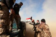 <p>Iraqi Counter-Terrorism Service (CTS) members help wounded civilian as they flee the violence in district of Maamoun in western Mosul,Iraq February 23, 2017. (Alaa Al-Marjani/Reuters) </p>