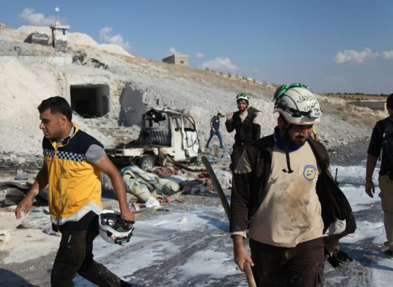 Syrian civil defence members on search through wreckage on September 8, 2018 left by an air strike on Idlib's southern town of Hass