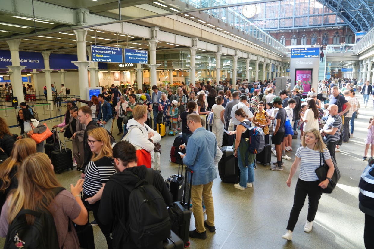 Passengers queue at the Eurostar terminal at St Pancras station in central London. French rail officials say several lines have been hit by 