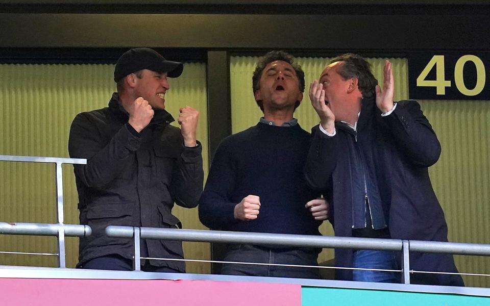 The Duke of Cambridge (left) celebrates a goal while watching a football match (PA)