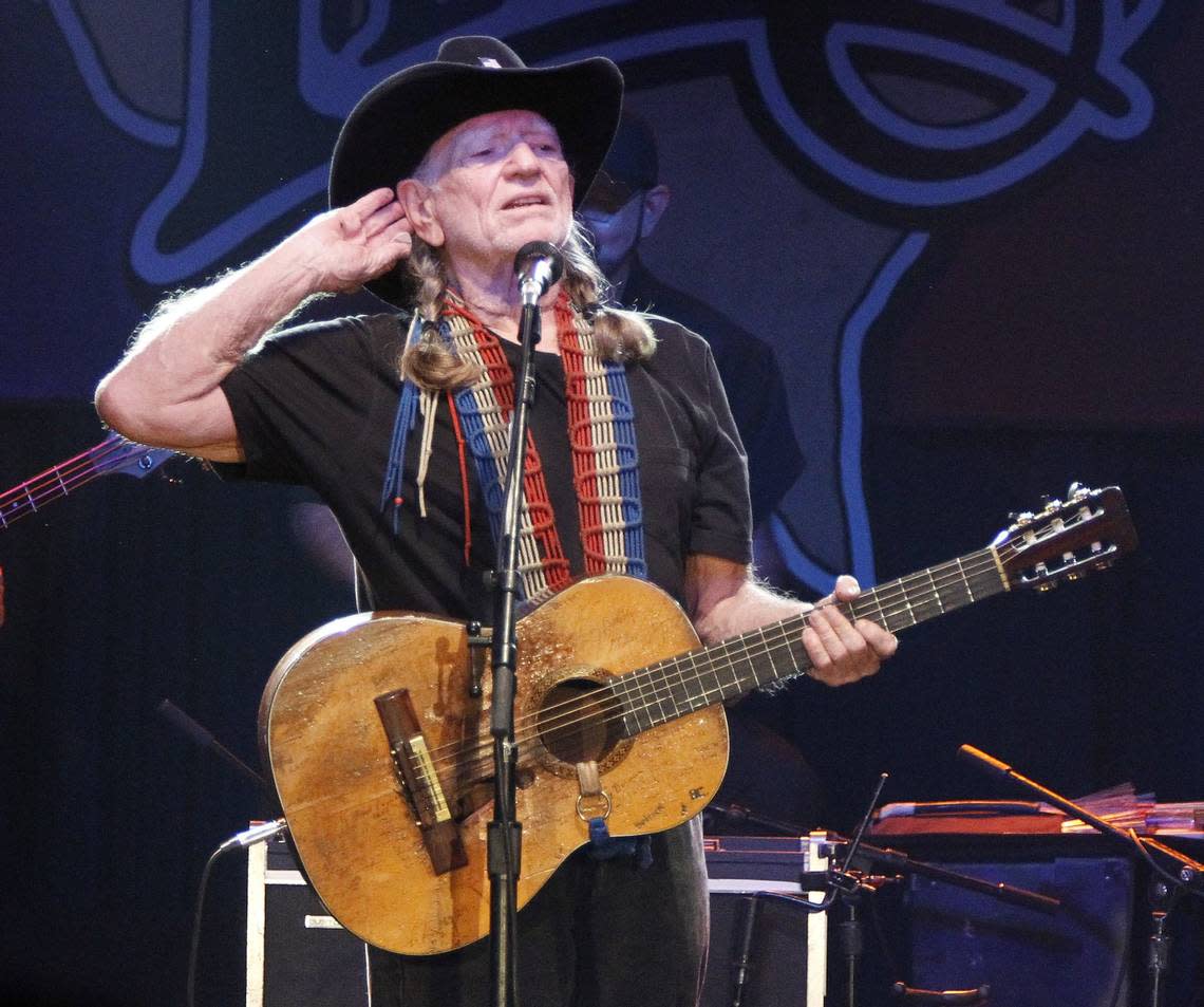 Willie Nelson becons the crowd at his Fourth of July Picnic on Monday July 4, 2011. (Star-Telegram/Ron T. Ennis)
