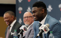 New Orleans Pelicans first-round NBA draft pick Zion Williamson, right, laughs at his introductory news conference at the team's practice facility in Metairie, La., Friday, June 21, 2019. Head coach Alvin Gentry, left, and executive vice president of basketball operations David Griffin, center, look on. (AP Photo/Gerald Herbert)