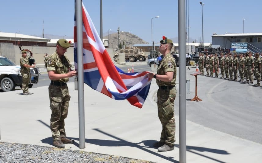 A flag lowering ceremony in Afghanistan - LEIGH GRAY/MOD