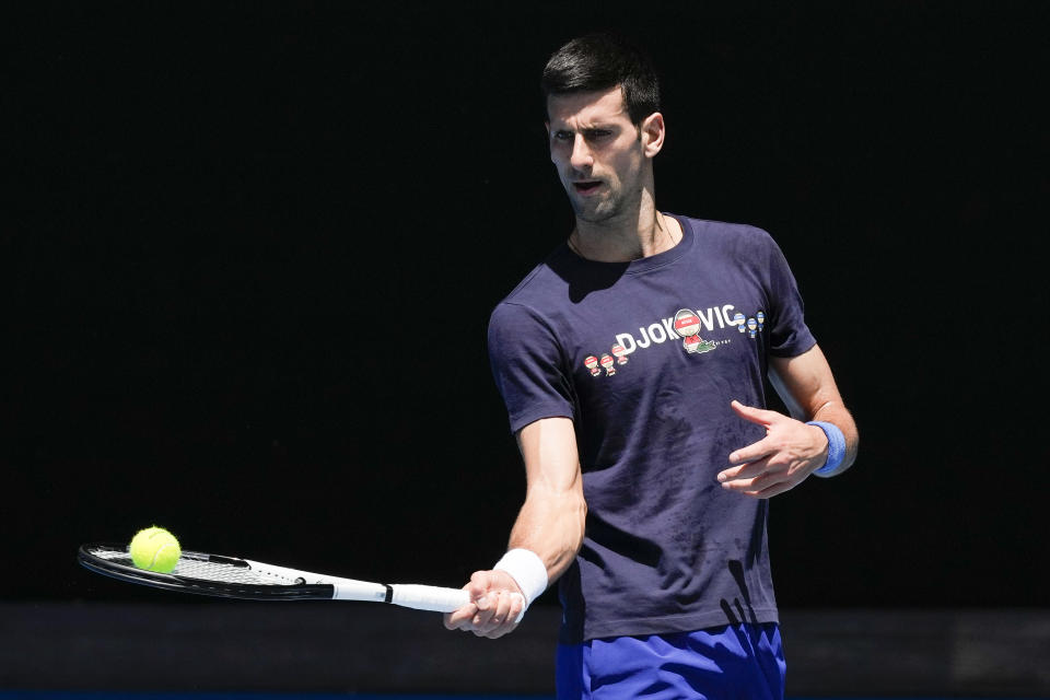 Defending men's champion Serbia's Novak Djokovic practices on Rod Laver Arena ahead of the Australian Open tennis championship in Melbourne, Australia, Wednesday, Jan. 12, 2022. AP Photo/Mark Baker)