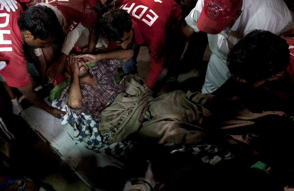 Volunteers unload an injured victim