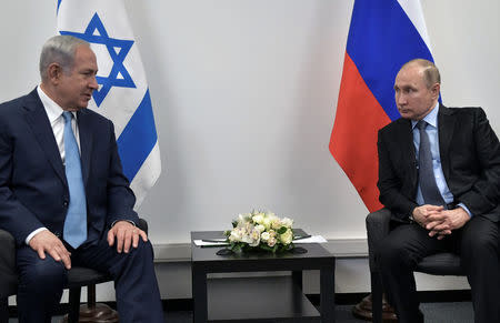 Russian President Vladimir Putin and Israeli Prime Minister Benjamin Netanyahu attend a meeting at the Jewish Museum and Tolerance Centre in Moscow, Russia January 29, 2018. Sputnik/Alexei Nikolsky/Kremlin via REUTERS