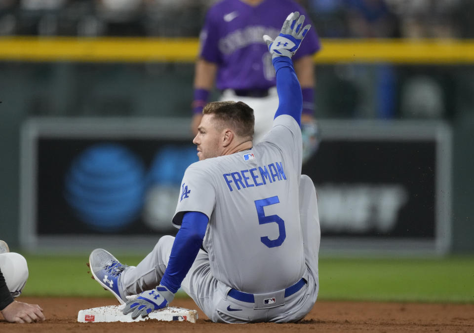 Los Angeles Dodgers' Freddie Freeman gestures after reaching second base on a double hit off Colorado Rockies relief pitcher Victor Vodnik in the ninth inning of the second game of a baseball doubleheader on Tuesday, Sept. 26, 2023, in Denver. (AP Photo/David Zalubowski)