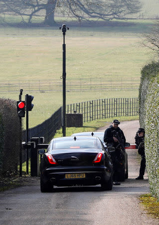 Armed police officers man the entrance to Chequers, the official country residence of the Prime Minister, as official cars arrive at the gates near Aylesbury, Britain, February 22, 2018. REUTERS/Darren Staples