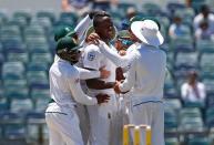 Cricket - Australia v South Africa - First Test cricket match - WACA Ground, Perth, Australia - 7/11/16. South Africa's Kagiso Rabada celebrates with team mates after dismissing Australia's Mitchell Starc at the WACA Ground in Perth. REUTERS/David Gray