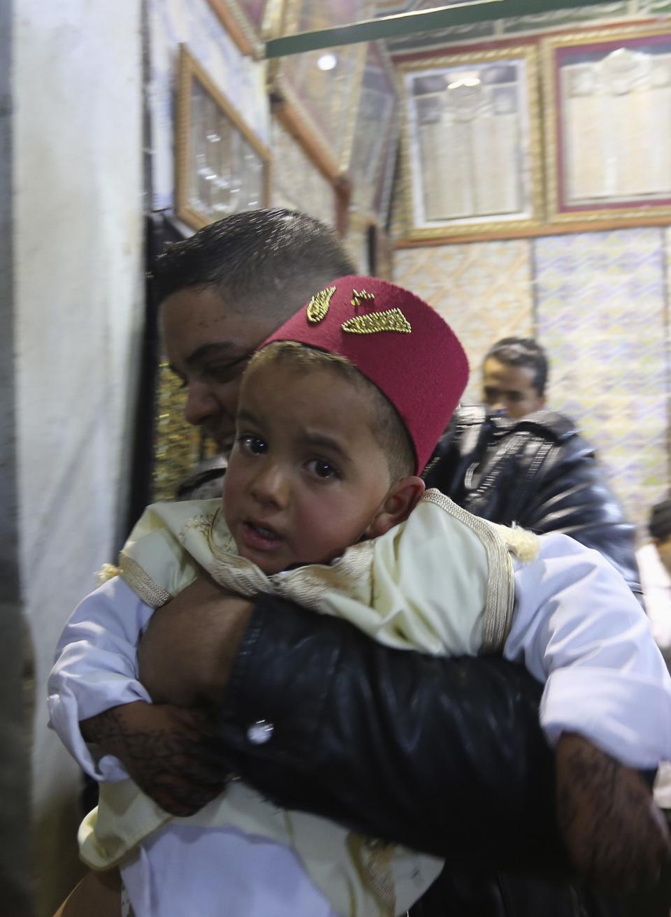 Muslim boy waits to be circumcised at Sidi Sahibi mausoleum during Eid-e-Milad-ul-Nabi, birthday celebrations of Prophet Mohammad, in Kairouan