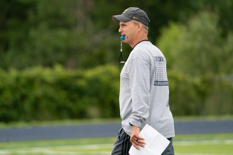 Saline head coach Joe Palka works with his team during practice at Saline High School on Monday, Aug. 7, 2023.