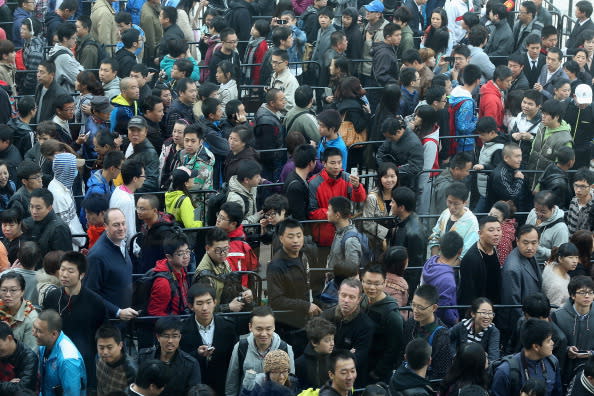 Chinese fans line up outside the new Apple Store in Wangfujing shopping district on October 20, 2012 in Beijing, China. Apple Inc. opened its sixth retail store on the Chinese mainland Saturday. The new Wangfujing store is Apple's largest retail store in Asia. (Photo by Feng Li/Getty Images)