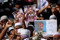 Muslims take part in a protest in Dhaka