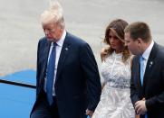 <p>President Trump walks with first lady Melania Trump and Estonian Prime Minister Juri Ratas as they arrive for a working dinner at the Parc du Cinquantenaire in Brussels on July 11, 2018, during the NATO summit. (Photo: Geoffroy Van Der Hasselt/AFP/Getty Images) </p>