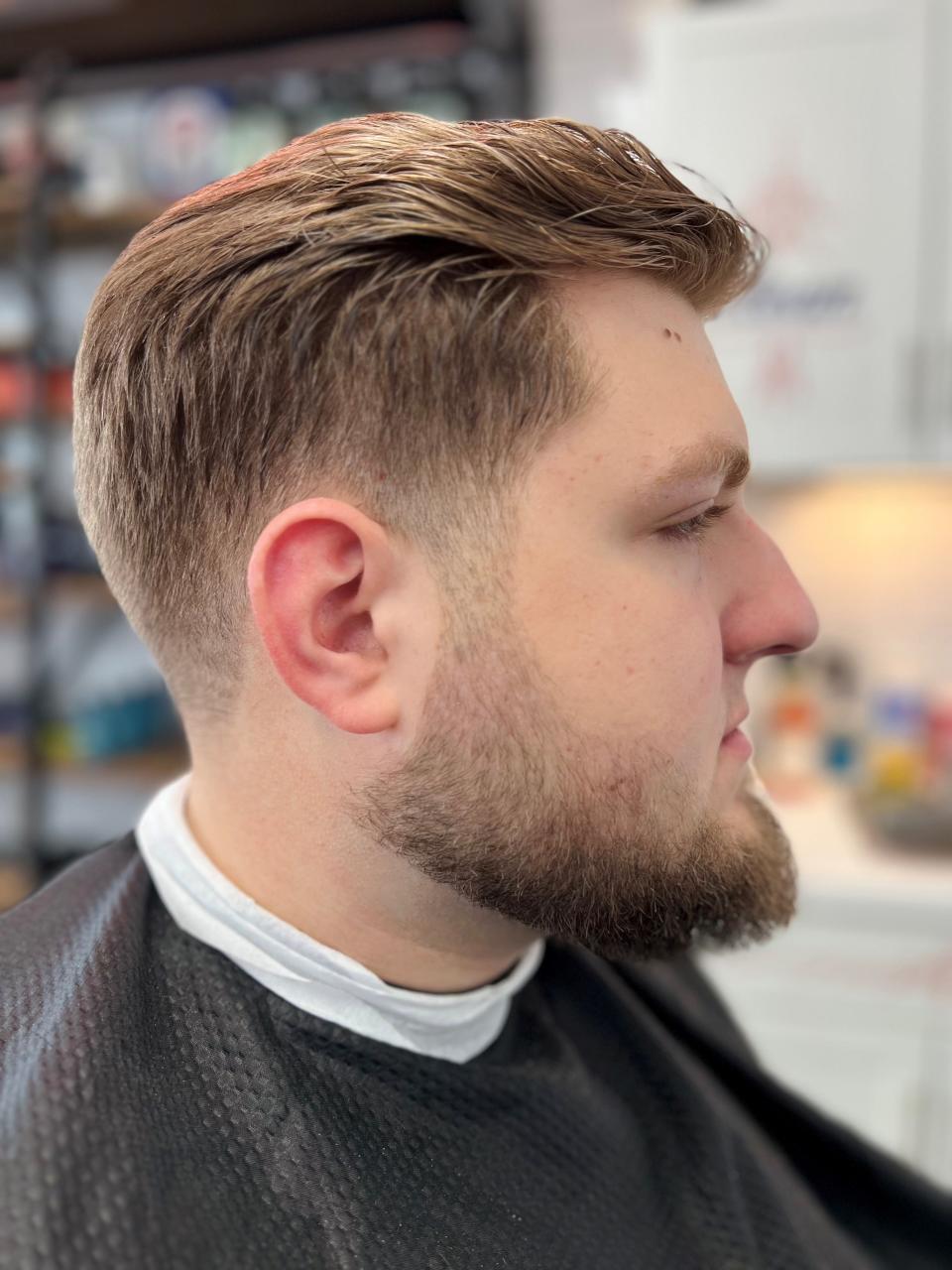 Jackson Vilot, son of master barber Steve Vilot, sports a beard shave at Barber Authority in Lynchburg, Tennessee on Oct. 28, 2022.