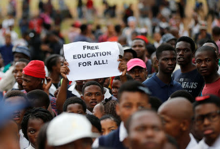 A protester holds up a placard as students gather outside South African President Jacob Zuma's offices demanding free university education, in Pretoria, South Africa October 20,2016. REUTERS/Siphiwe Sibeko