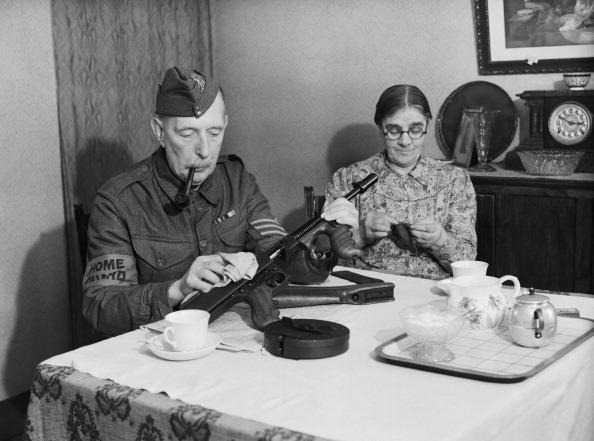 <p>A Sergeant of the Dorking Home Guard in Surrey, England gives his gun a final polish before leaving home to go on parade in 1940. (Lt. Len Puttnam/ IWM via Getty Images)</p>