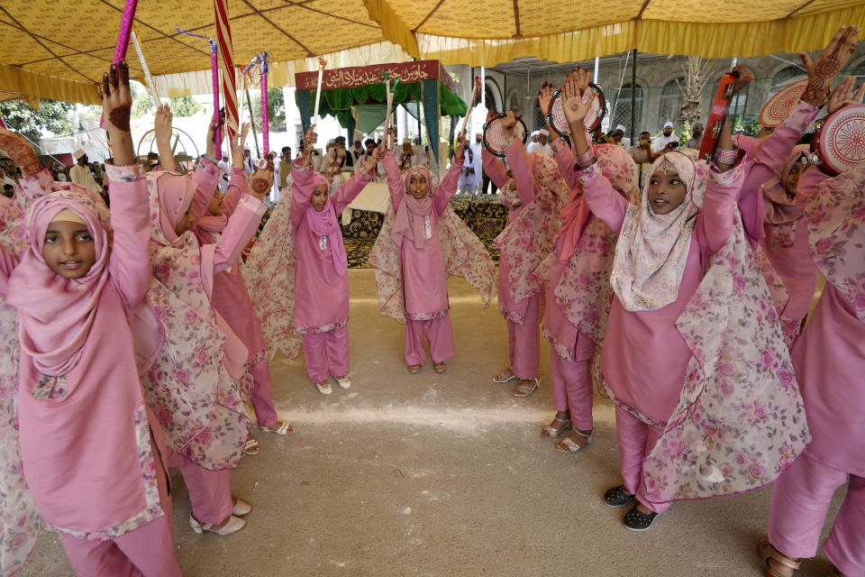 Girls in traditional dresses take part in a ceremony celebrating the birthday of Islam's Prophet Muhammad, in Karachi, Pakistan, Friday, Sept. 29, 2023. Thousands of Muslims take part in religious processions, ceremonies and distributing free meals among the poor to mark the holiday. (AP Photo/Fareed Khan)