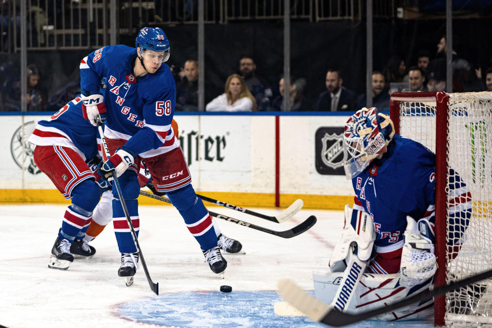 New York Rangers defenseman Brandon Scanlin (58) attempts to clear the puck during the first period of the team's NHL hockey game against the Philadelphia Flyers on Tuesday, March 26, 2024, in New York. (AP Photo/Peter K. Afriyie)