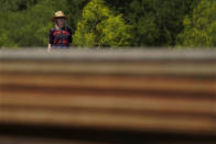 Molly Rooke checks on an abandoned well at her family ranch that was being plugged, Tuesday, May 18, 2021, near Refugio, Texas. Rooke, who co-owns the family ranch had an orphaned well blow out on her property, spewing chemicals into the air. The 15,000-acre ranch contained dozens of orphaned, unplugged wells, with pipes not much taller than her own frame. (AP Photo/Eric Gay)