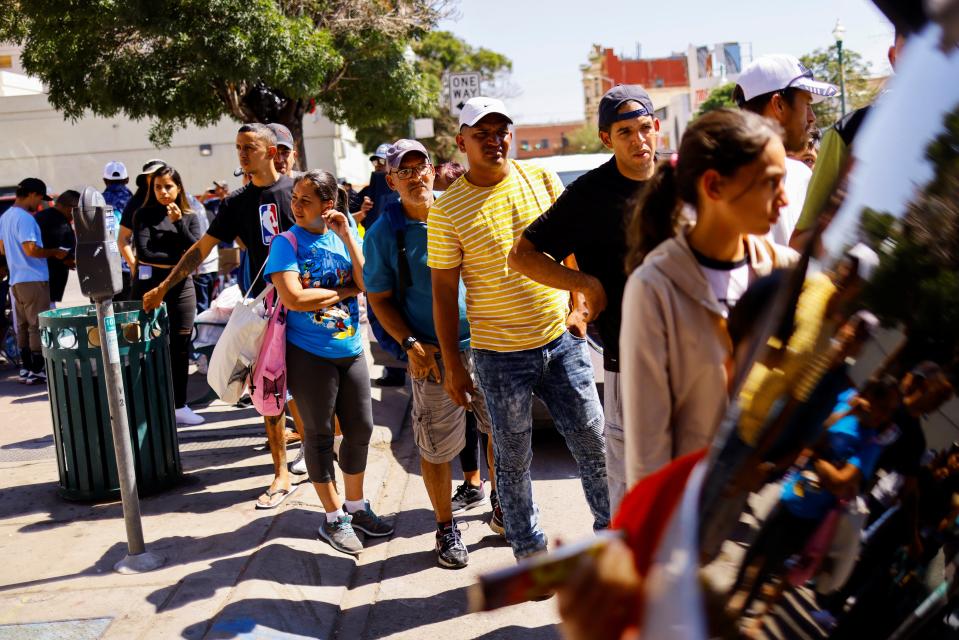 Migrants gather to received donated clothes near a bus station after being released from U.S. Border Patrol custody in El Paso, Texas, U.S., September 17, 2022 (REUTERS)