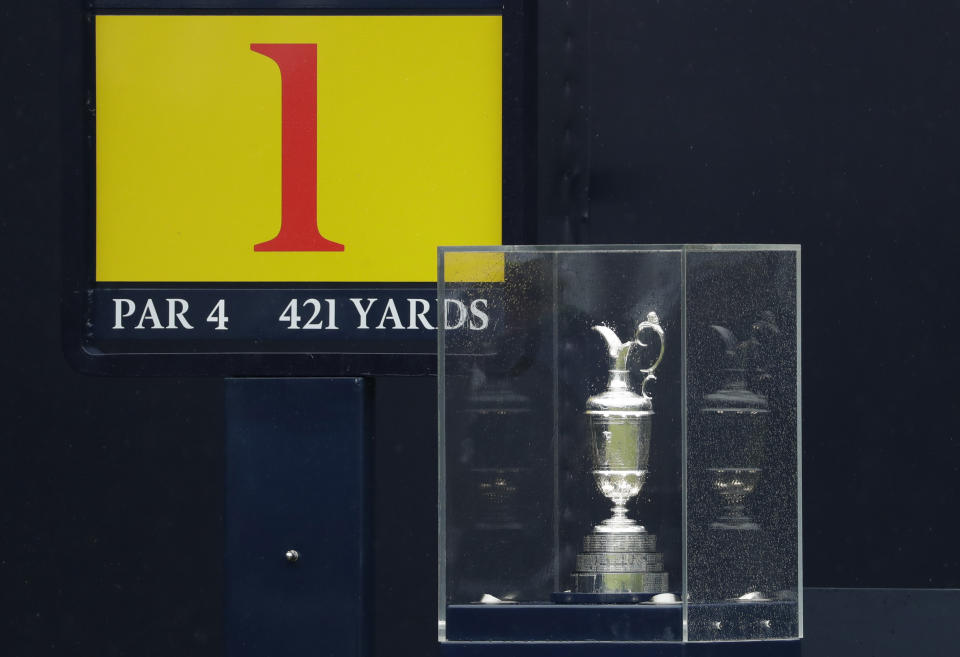 FILE - In this Sunday, July 21, 2019 file photo protected by a glass case the famous Claret Jug stands on the 1st tee the British Open Golf Championships at Royal Portrush in Northern Ireland. The organizers of the British Open announced Monday April 6, 2020, that they have decided to cancel the event in 2020 due to the current Covid-19 pandemic and that the Championship will next be played at Royal St George's in 2021. (AP Photo/Matt Dunham)