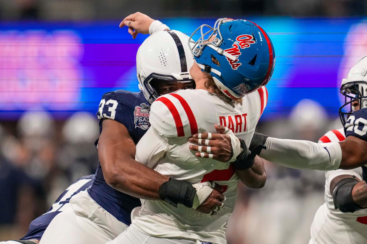 Dec 30, 2023; Atlanta, GA, USA; Penn State Nittany Lions defensive end Dani Dennis-Sutton (33) hits Mississippi Rebels quarterback Jaxson Dart (2) during the first quarter at Mercedes-Benz Stadium. Mandatory Credit: Dale Zanine-USA TODAY Sports