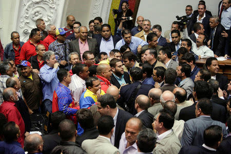 Deputies of the Venezuelan coalition of opposition parties (MUD) and of the Venezuela's United Socialist Party (PSUV) scuffle during a session of the National Assembly in Caracas, Venezuela October 25, 2016. REUTERS/Marco Bello