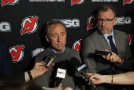 New Jersey Devils owner Josh Harris, left, announces interim general manager Tom Fitzgerald, right, to replace Ray Shero prior to an NHL hockey game Sunday, Jan. 12, 2020, in Newark, N.J. (AP Photo/Adam Hunger)