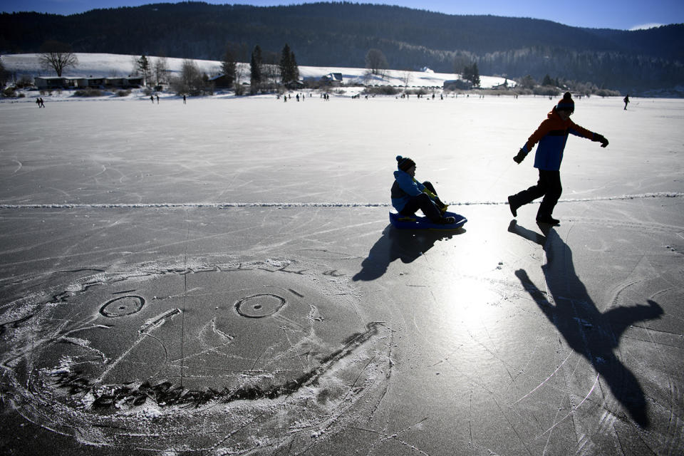 People skate on frozen lake Lac de Joux