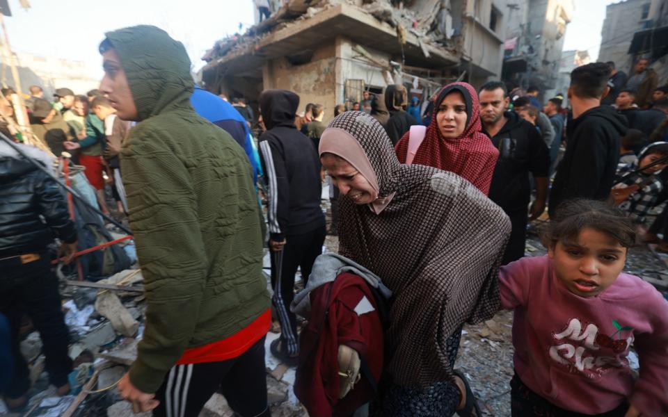 Palestinians rush out of a bombarded area in the Rafah refugee camp