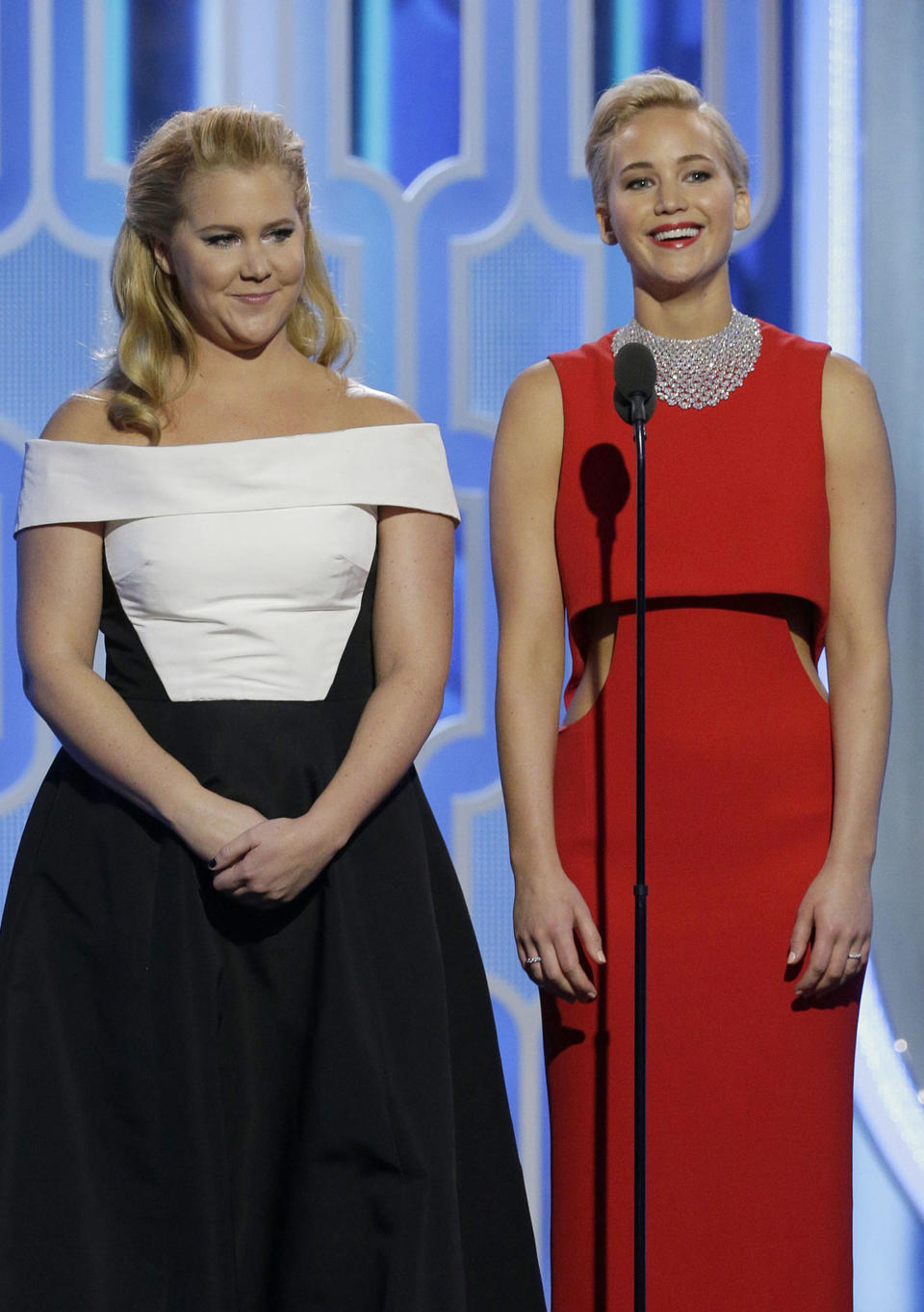 Amy Schumer and Jennifer Lawrence speak onstage during the 73rd Annual Golden Globe Awards. (Photo: Handout via Getty Images)