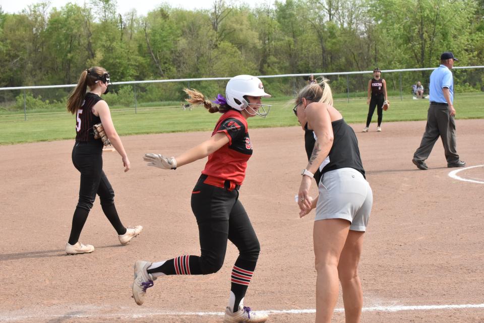 Clinton's Kendall Phillip rounds third and celebrates with her coach and mother, Kim Phillip, during a doubleheader at Hudson.