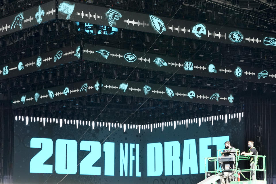 Workers continue preparing the NFL Draft Theatre for the 2021 NFL Draft, Tuesday, April 27, 2021, in Cleveland. After going all virtual in 2020 due to the COVID-19 pandemic, the three-day draft, which has grown into one of America's biggest, non-game sporting events, returns with thousands of fans who will be separated by their loyalties, and whether they've been vaccinated. (AP Photo/Tony Dejak)