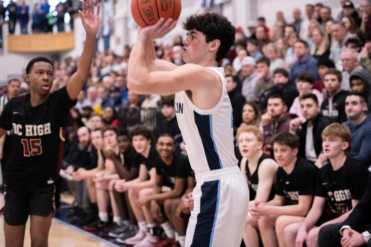 Franklin senior captain Andrew O'Neill shoots for 3 points as BC High junior James Jones closes in, during the Division 1 Elite 8 game at Franklin High, March 9, 2024. The Panthers beat the Eagles, 66-49.