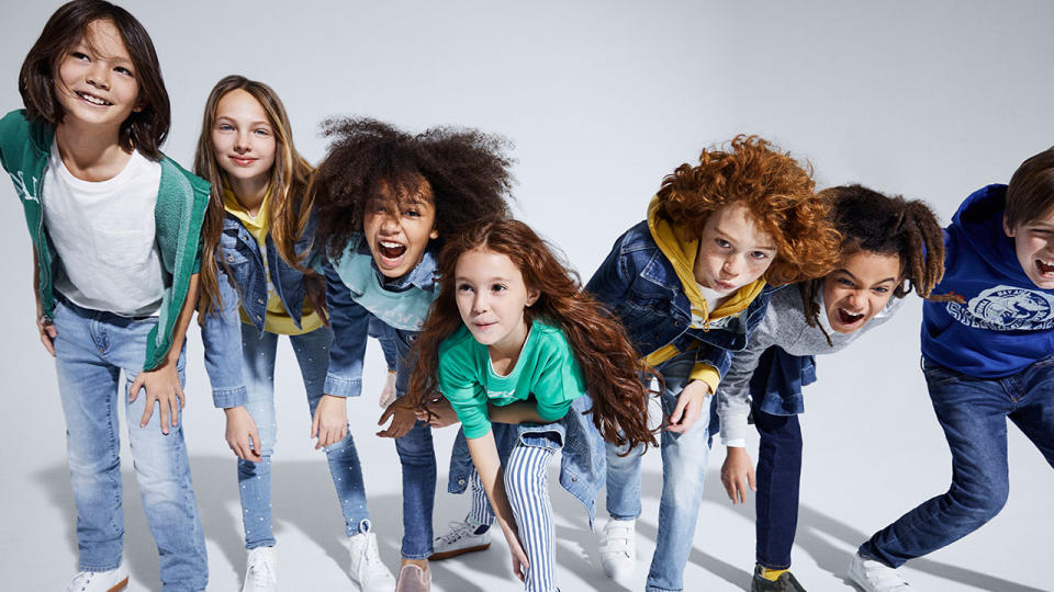 Group of smiling kids leaning in