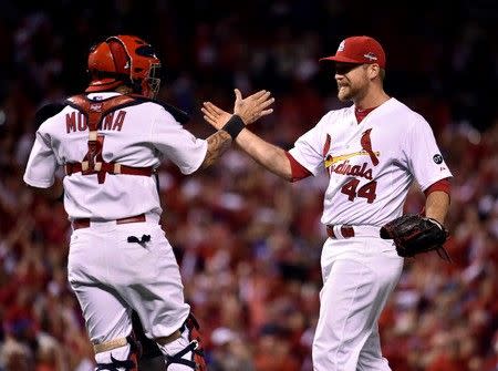 Oct 9, 2015; St. Louis, MO, USA; St. Louis Cardinals relief pitcher Trevor Rosenthal (44) celebrates with catcher Yadier Molina (4) after defeating the Chicago Cubs in game one of the NLDS at Busch Stadium. Mandatory Credit: Scott Rovak-USA TODAY Sports