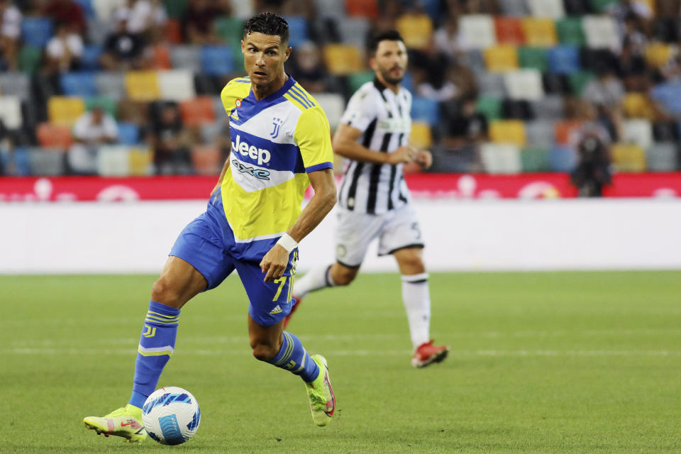 Juventus' Cristiano Ronaldo goes for the ball during the Serie A soccer match between Udinese and Juventus, at the Dacia Arena in Udine, Italy, Sunday, Aug. 22, 2021. (Andrea Bressanutti/LaPresse via AP)