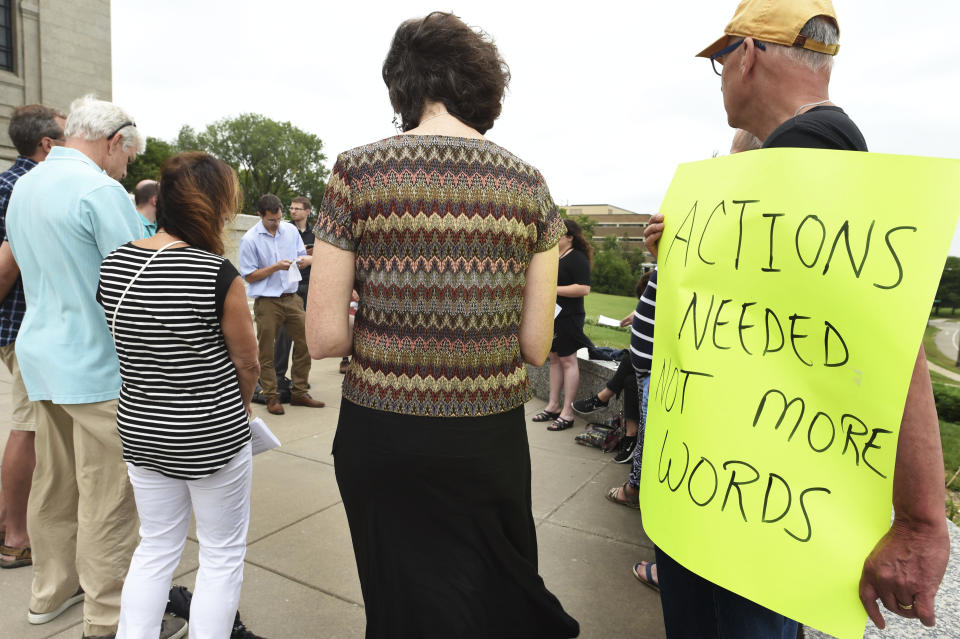 In this Aug. 26, 2018 photo, Rob Super, right, holds a sign as nearly two dozen people gather outside the Cathedral of St. Paul in St. Paul, Minn., to demand action from the Catholic Church and show solidarity for victims of abuse. Members of the Catholic laity are raising their voices in prayer and protest after new revelations of sex abuse by priests and allegations of cover-ups by church leaders. From petitions that demand answers to prayer vigils that spanned several cities, Catholic faithful are taking action, saying it's now up to the laity to confront the culture of clericalism that has allowed sex abuse to persist. (Scott Takushi, Pioneer Press via AP)