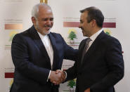 Lebanese Foreign Minister Gebran Bassil, right, shakes hands with his Iranian counterpart Mohammad Javad Zarif, in Beirut, Lebanon, Monday, Feb. 11, 2019. Zarif extended an offer for Iranian military assistance to the U.S.-backed Lebanese army on Sunday, saying Iran is ready to assist in all sectors should the Lebanese government want it. (AP Photo/Hussein Malla)